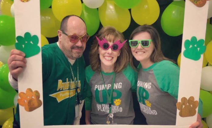 Mr. Pagel, Mrs. Martyka, Mrs. Cidlik holding sign with balloons