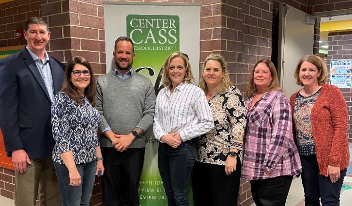 District 66 board members standing in front of Center Cass sign