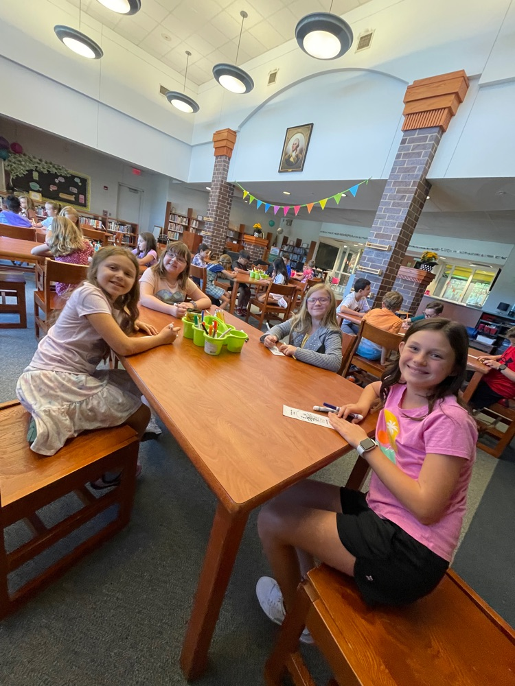 students at a table making a bookmark