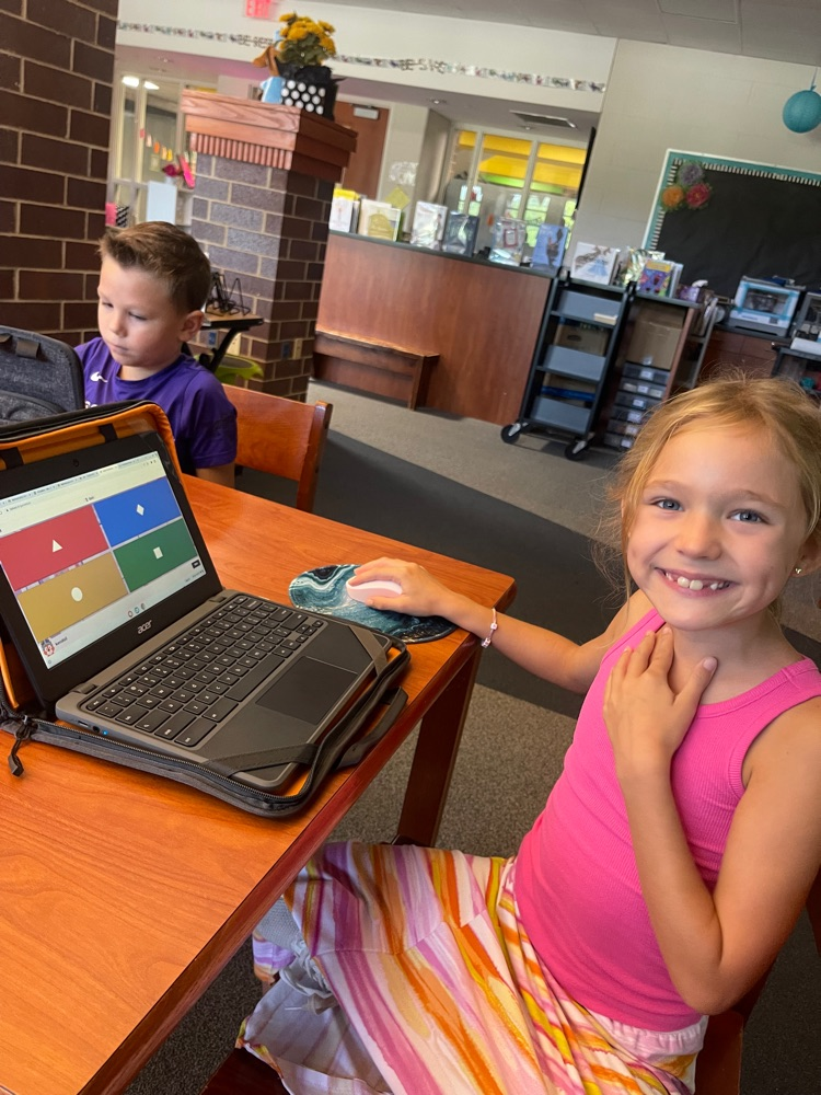 student playing Kahoot! and smiling 